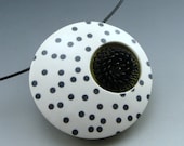 Funky modern pendant necklace in black and white with a pop of color