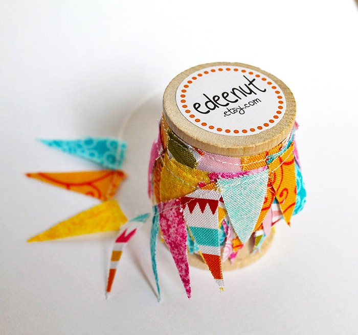 Sherbet Mix fabric Cake Mini Bunting. Wooden Spool of Ribbon for gift wrapping.