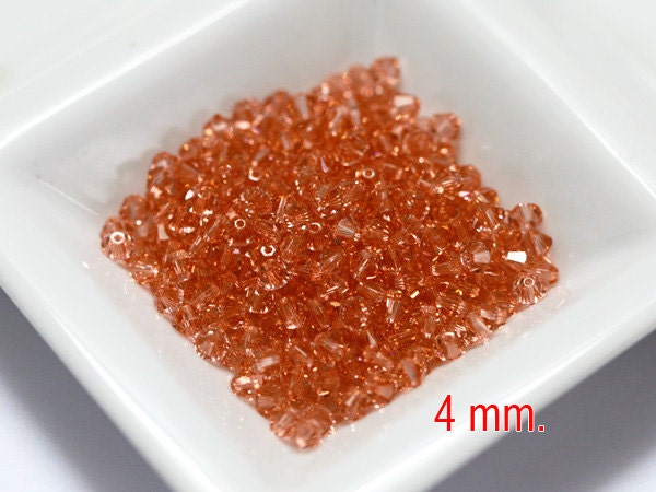 100 pcs. Rose Peach Swarovski Crystal Bicone 4 mm.