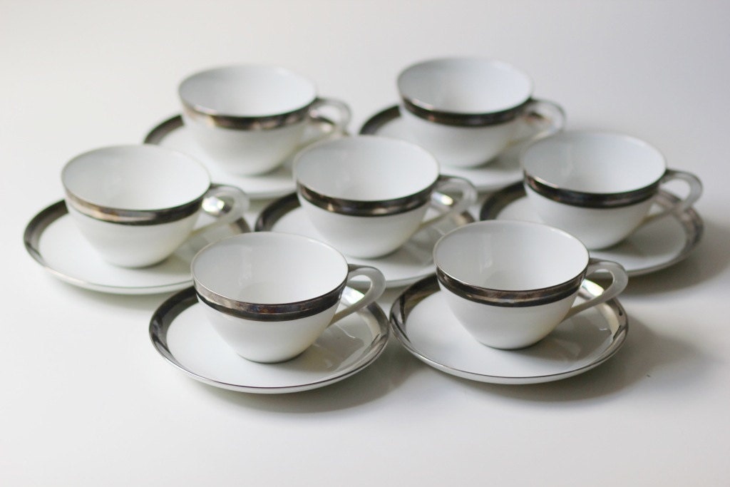 set of 7 teacup and saucers by Wincraft Saturn pattern white with platinum band excellent cond.