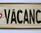 No Vacancy sign painting on antique wood door panel