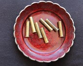 7 empty brass shell casings - 27x7mm