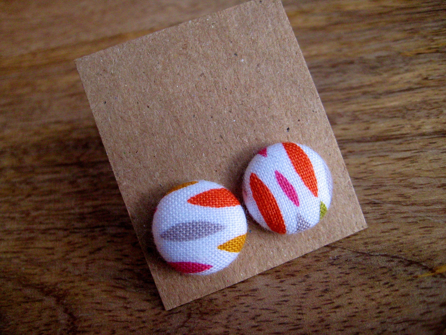 button earrings - various colors including pinks, green, grey, yellow, and red orange on white - pattern placement varies