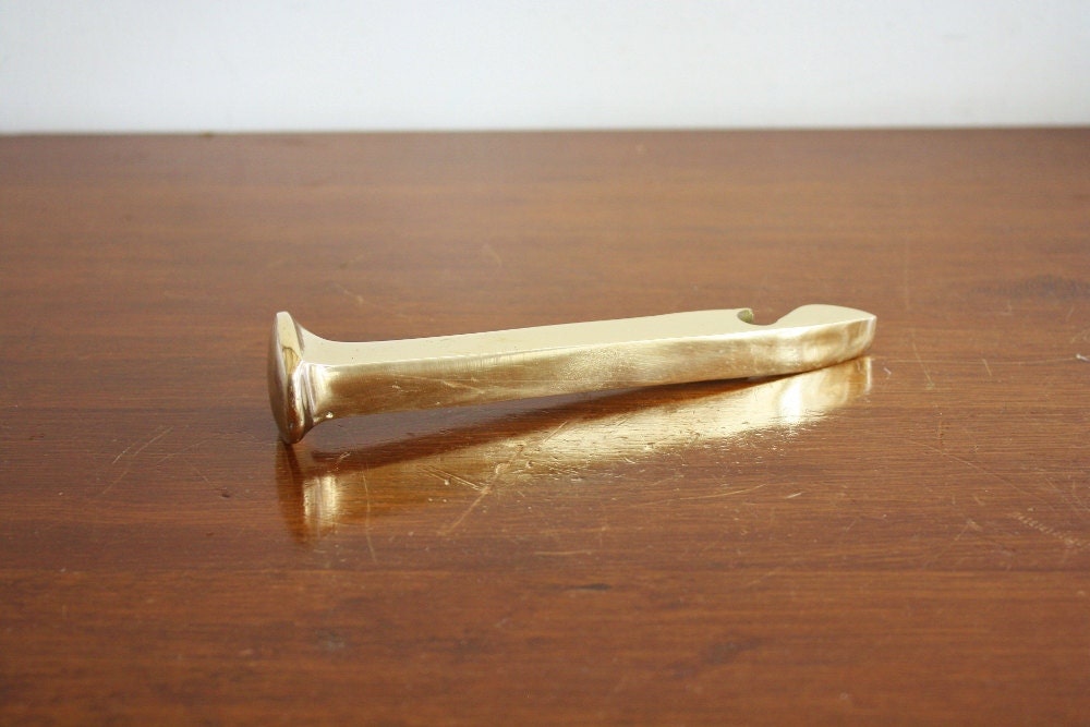 Vintage brass railroad spike bottle opener