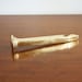 Vintage brass railroad spike bottle opener