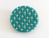 emerald green round sashiko brooch with white crosses