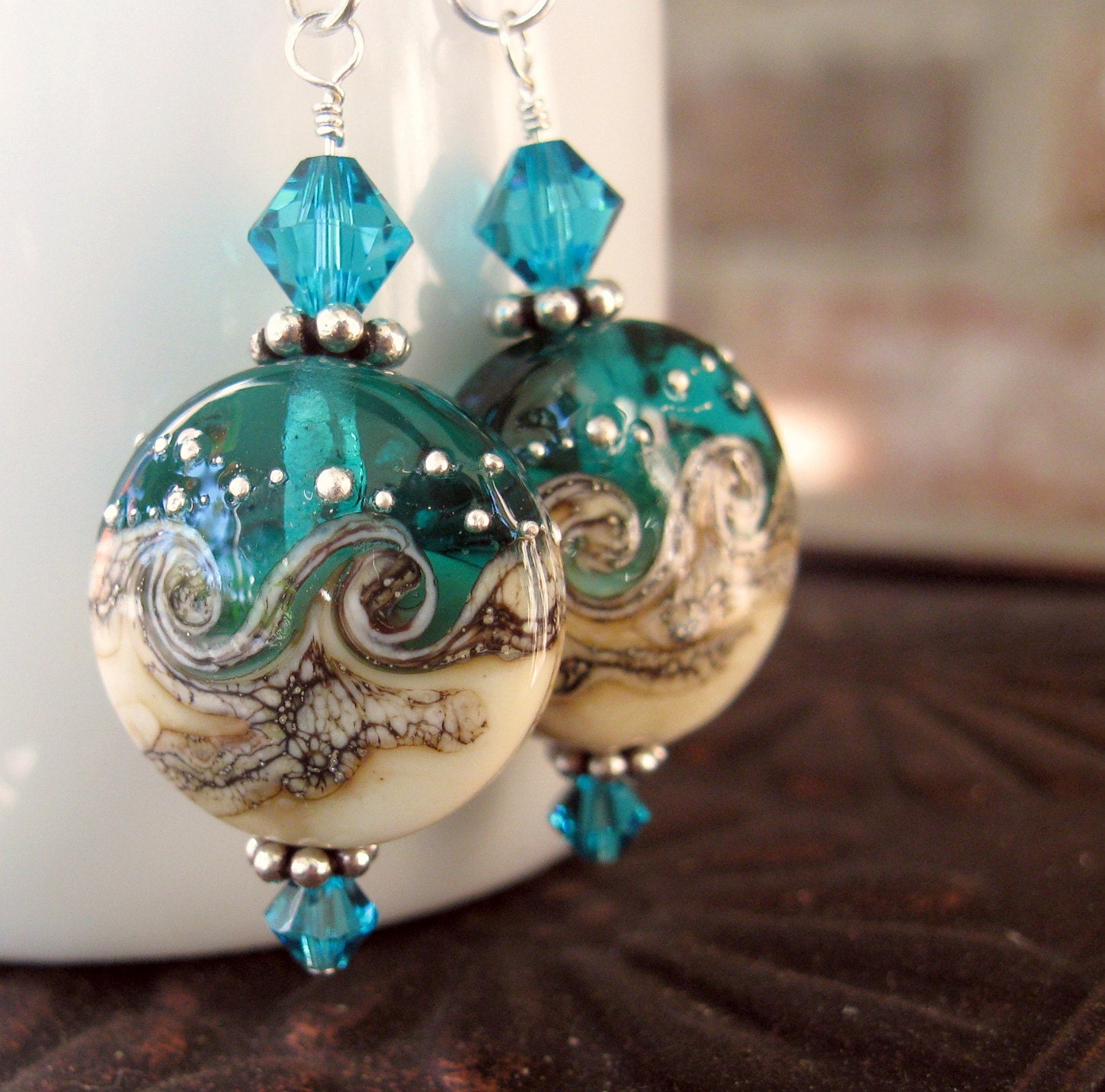 Ocean themed earrings. Lampwork glass dangles with aquamarine crystals. Sterling silver, hypoallergenic.