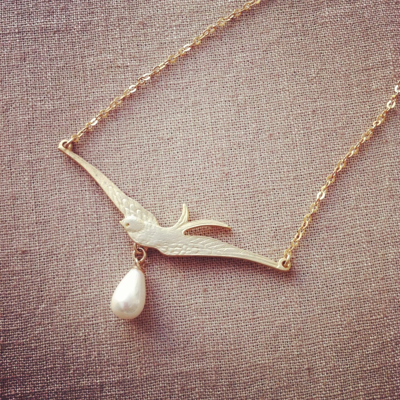 Gold plated Bird necklace with a dangle pearl, spring fashion