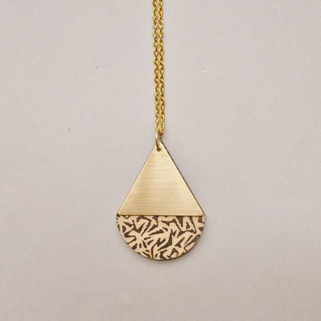 Animal print teardrop brass and wood necklace.