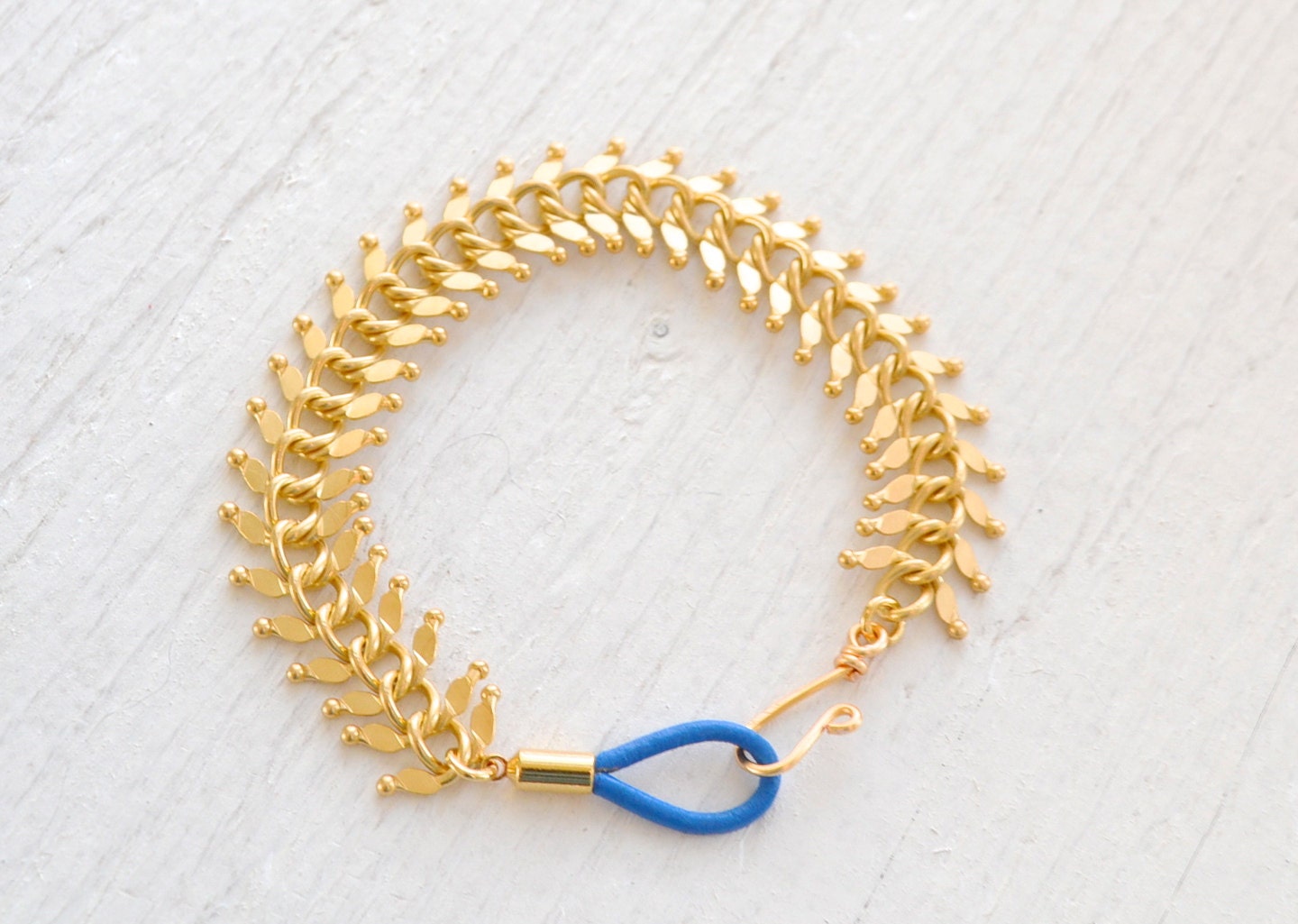 Fishbone Matte Gold Bracelet with Blue Leather Clasp