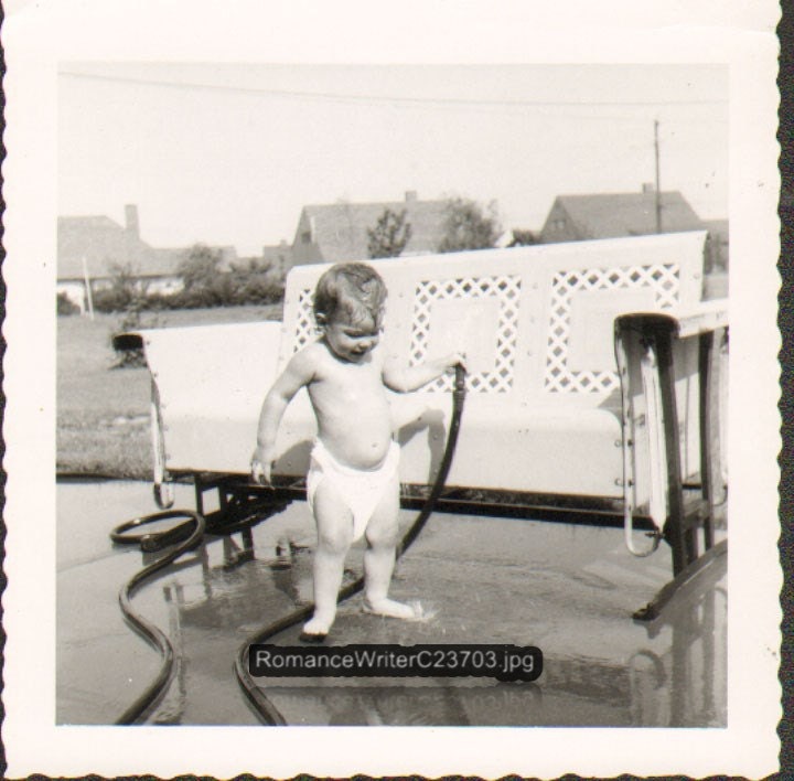 Cooling Off Vintage Photo of a Cute Baby in a Diaper Wetting Itself with a Garden Hose