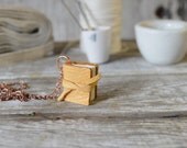Book Necklace: Medium, mid-century deerskin, tied.