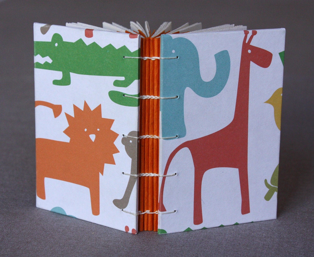 Small journal or baby shower guestbook with colorful animal print covers