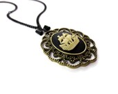 Shipwrecked Necklace - Nautical Boat Ship Black Gold Bow Antiqued Charm