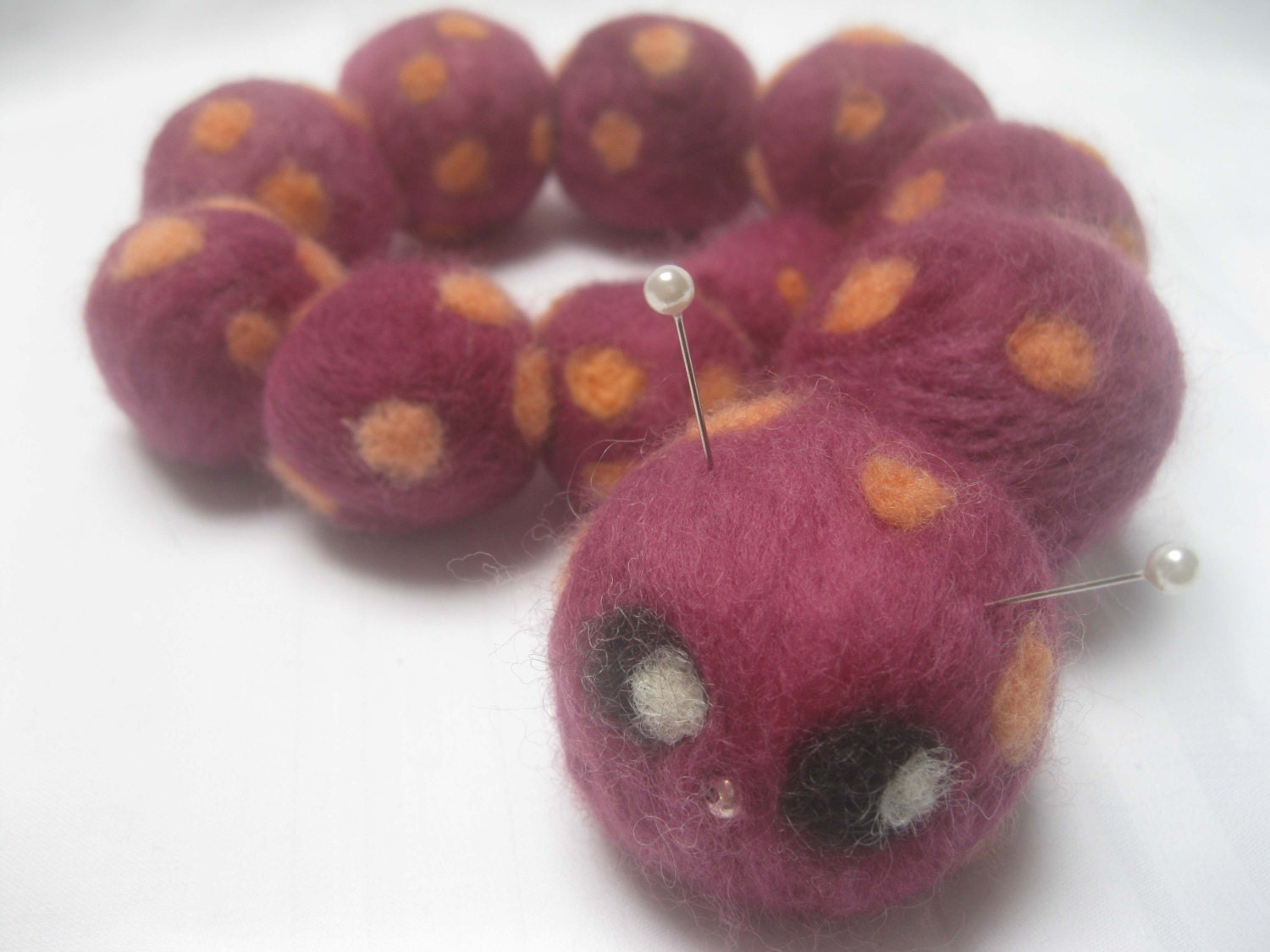 Cuthbert the Needlefelted Caterpillar Pin Cushion. Plum with Orange Spots