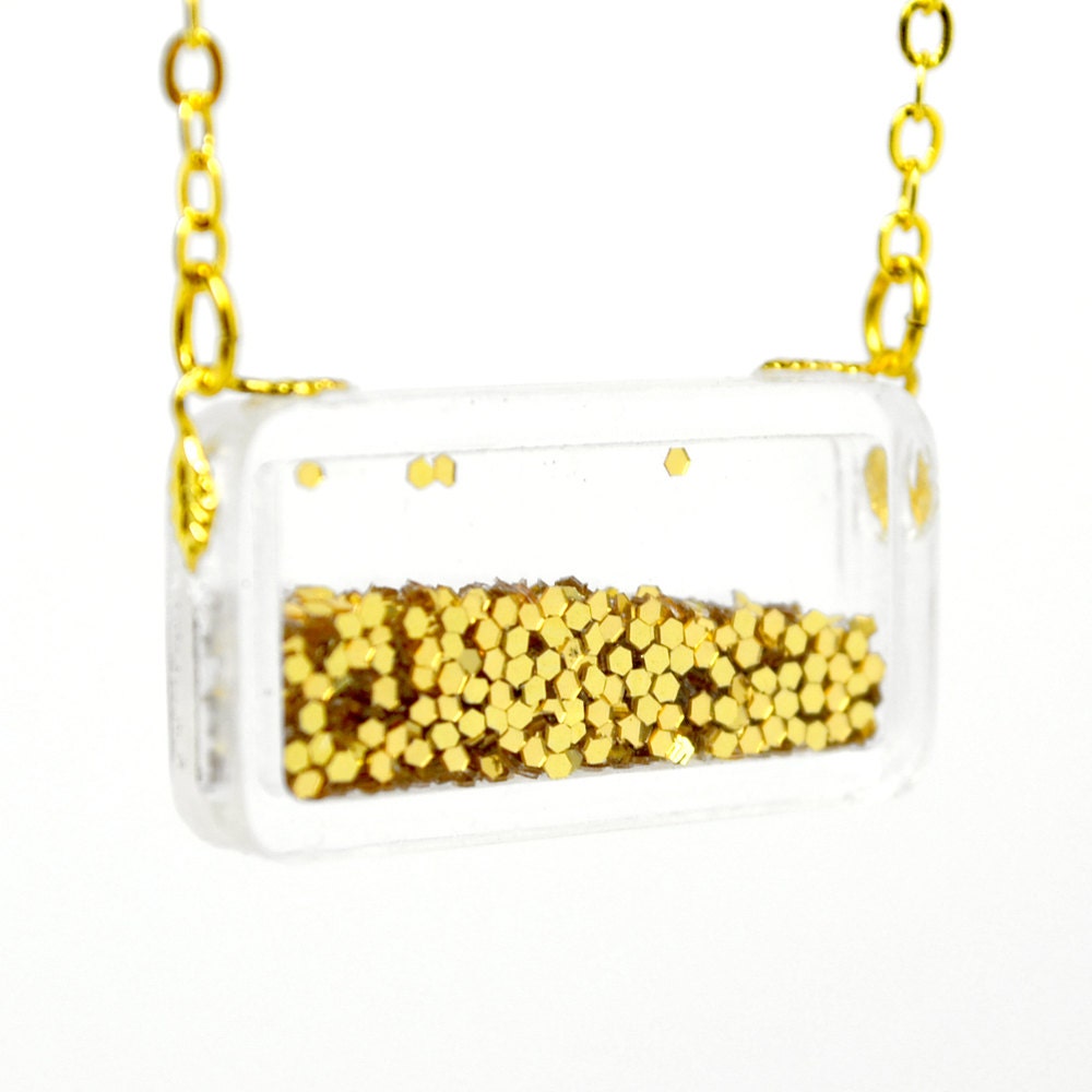 Golden round glitter in rectangular acrylic box gold tone pendant