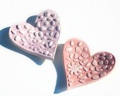 Two little heart tea dishes with imprinted design