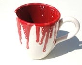 Coffee cup with drips of red and white dotting