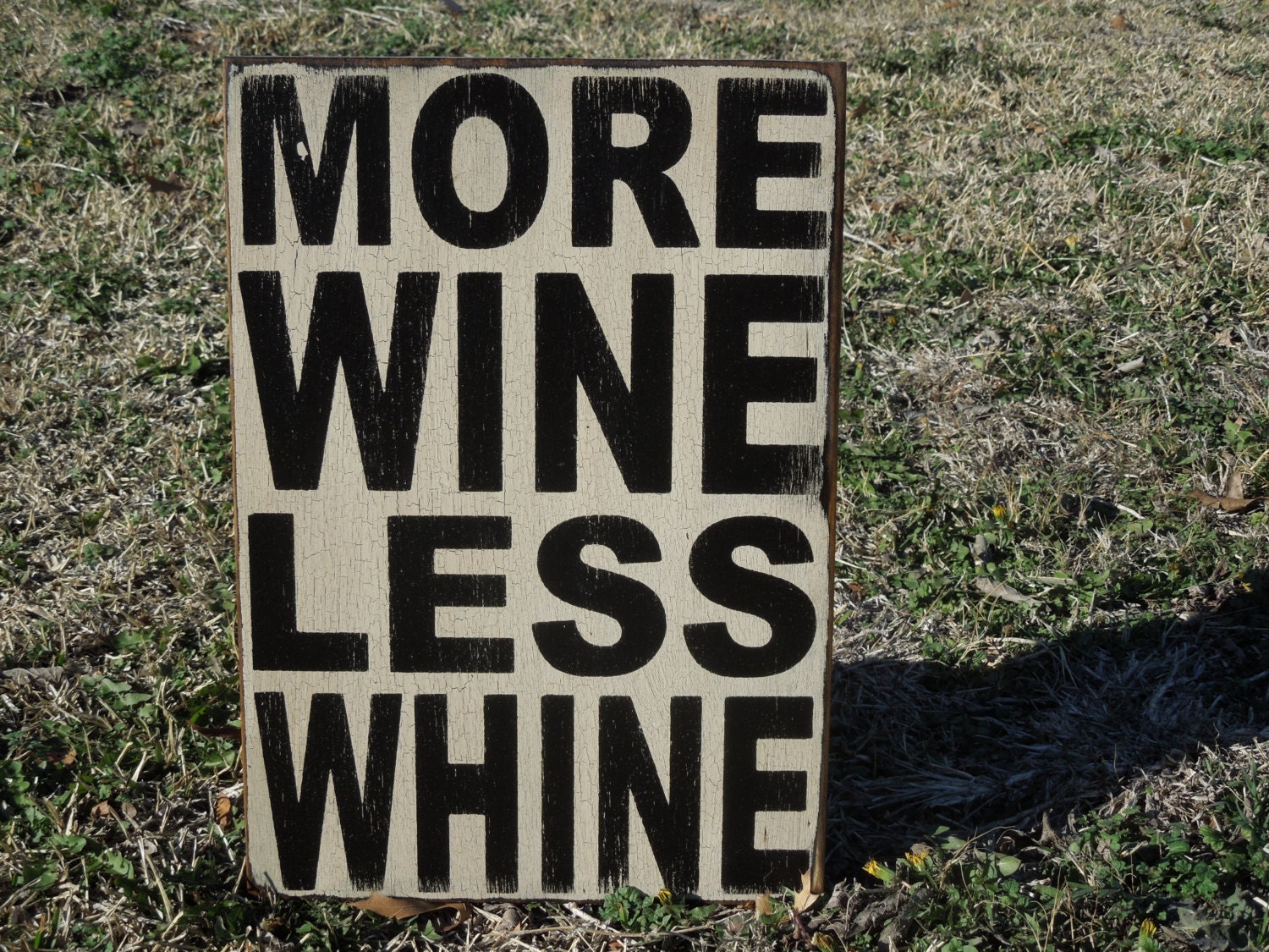 More wine less whine sign made from reclaimed plywood