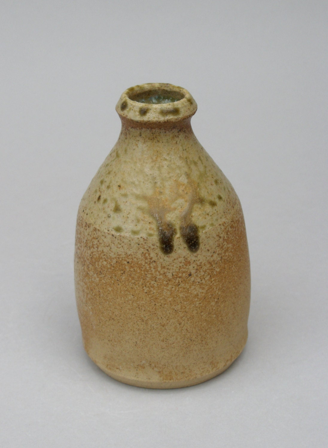 Small stoneware vase with ash