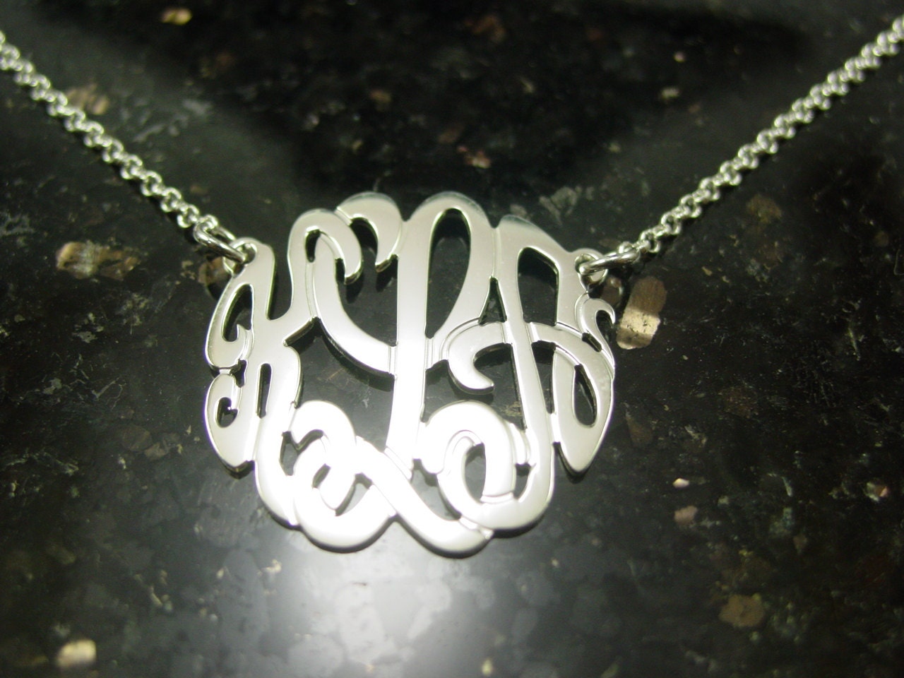 sterling silver monogram necklace .1."size. with a  silver chain.