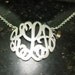 monogram necklace .1."size. with a  silver chain.