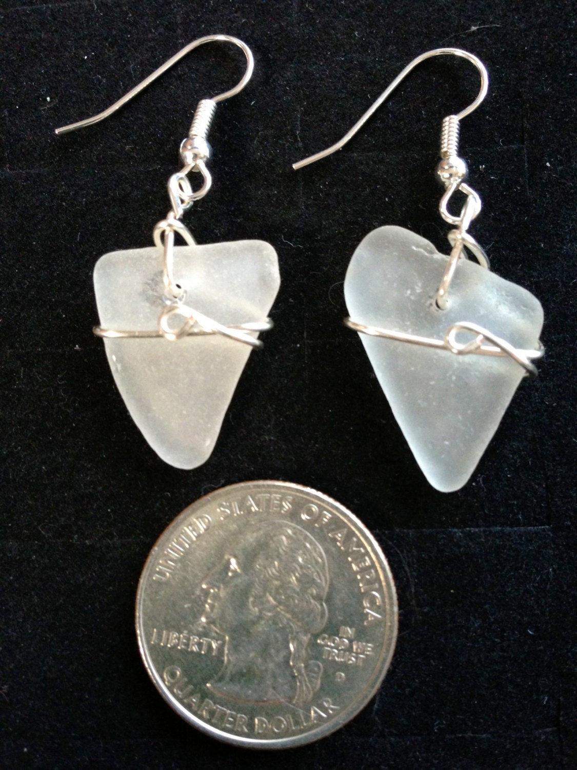 Surf tumbled white sea glass wire wrapped with wire.