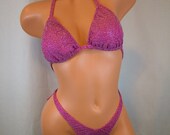 Bright pink, silver and purple glitter, two piece figure suit.