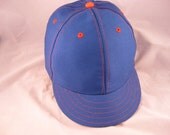 Royal Blue cotton 6 panel cap with cotton sweatband. Contrasting orange stitching.