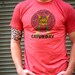 Mayan Laser Caturday Heather Red Tee with neon green laser eyes