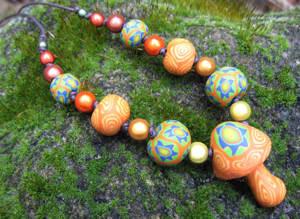 Millefiori mushroom pendant necklace handmade in orange and green with spirals and stars on thin adjustable cord