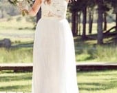 strapless lace wedding dress with handmade flowers applied over the bust, soft tulle skirt