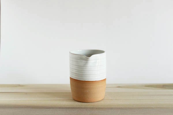 White ceramic pitcher, white creamer, on medium brown pottery, julia paul pottery