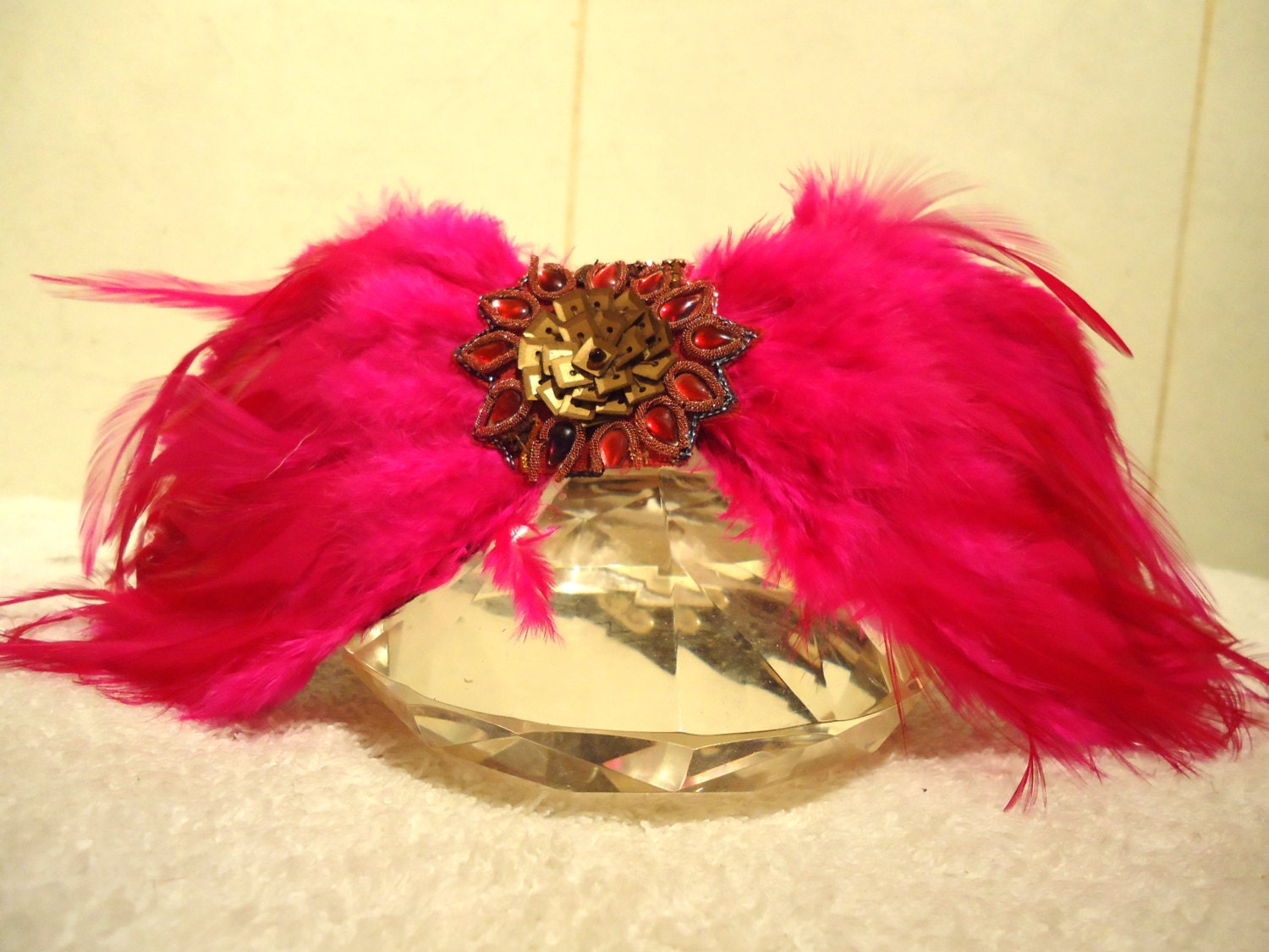 Couture dog collar. Center metal flower with faux gems and Cerise feather surround.
