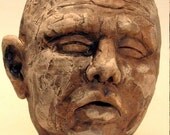 Man snoring loudly.  Ceramic wall piece.