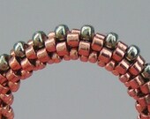 Woven beaded ring: gold, bronze, and emerald glass beads