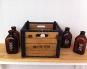 Old milk crate with glass amber milk jugs
