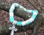 Cross beaded stretchy bracelet. Blue, green, white, shell.