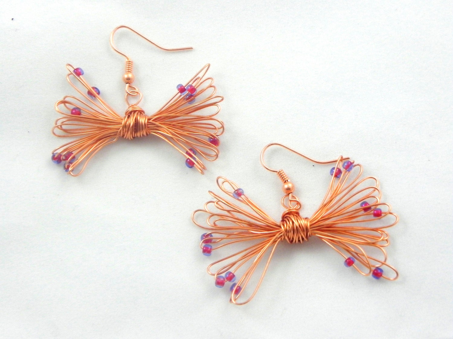 copper wire earring, hand wrapped with magenta glass bead detail, bow earring, preppy jewelry