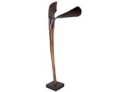 Unique wonderfully organic handmade sculpture featuring a lacquered palm leaf mounted on a black metal stand