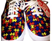 Canvas shoes with colorful patterns. Puzzle pieces in blue, red, teal and yellow.
