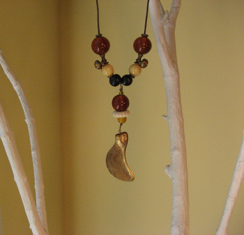 Beaded necklace with brass maple seed pod on waxed cotton cording