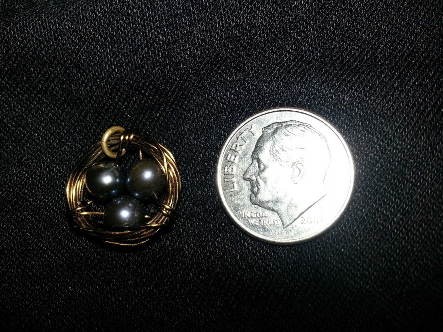 Miniature wire wrapped birds nests with white or blue beads for eggs.