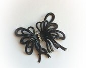 Vintage Plastic Black Bow Brooch with Rhinestone Center