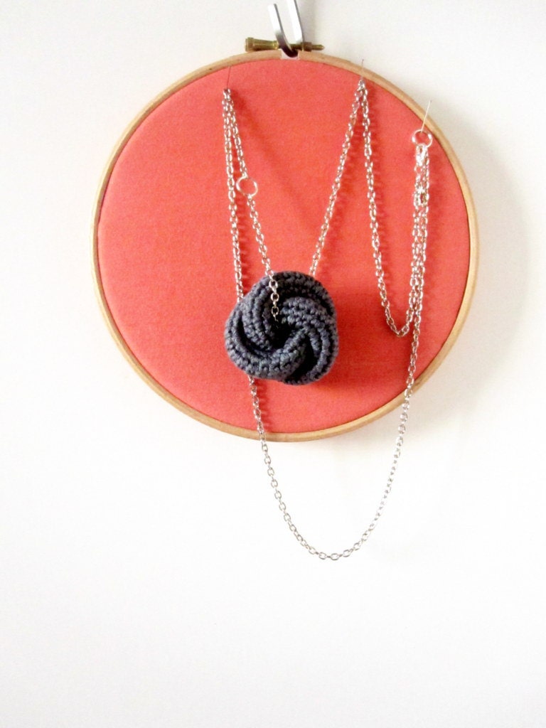 Eternally. Crochet knot pendant in concrete grey.