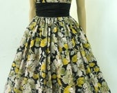 A limited edition black and yellow floral 100% cotton 50s inspired cocktail dress