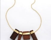 Heads or Tails wooden hand-carved  necklace with golden plated  elements.