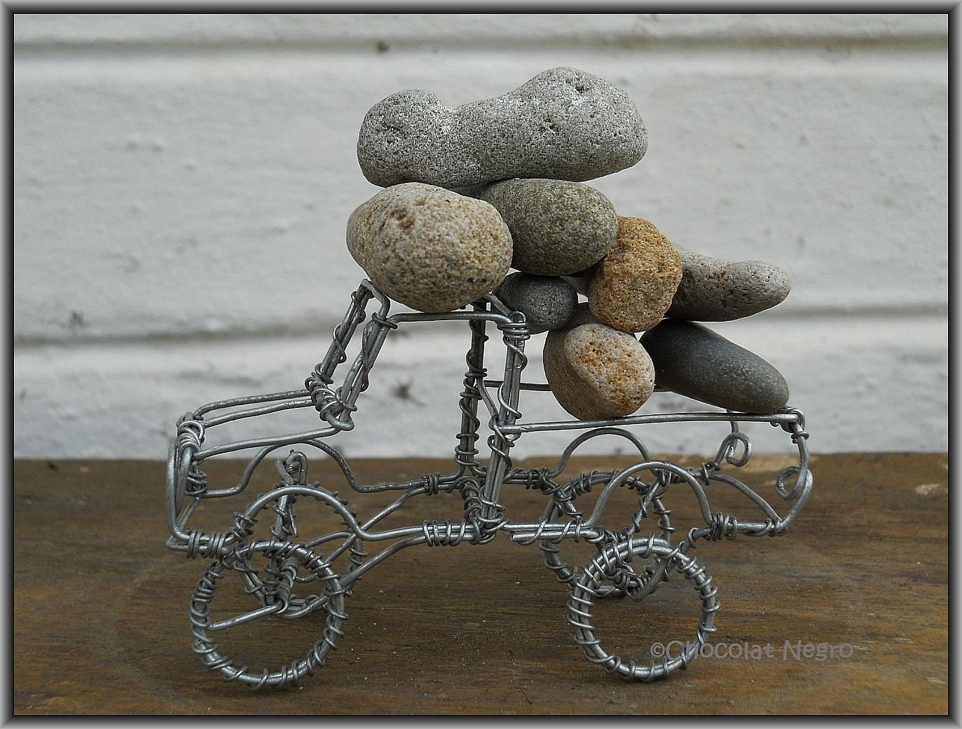 OVERLOAD - A LANDROVER CAN NEVER BE BROUGHT TO HIS KNEES - THE LANDROVER SERIES recycled wire art sculpture of a landrover