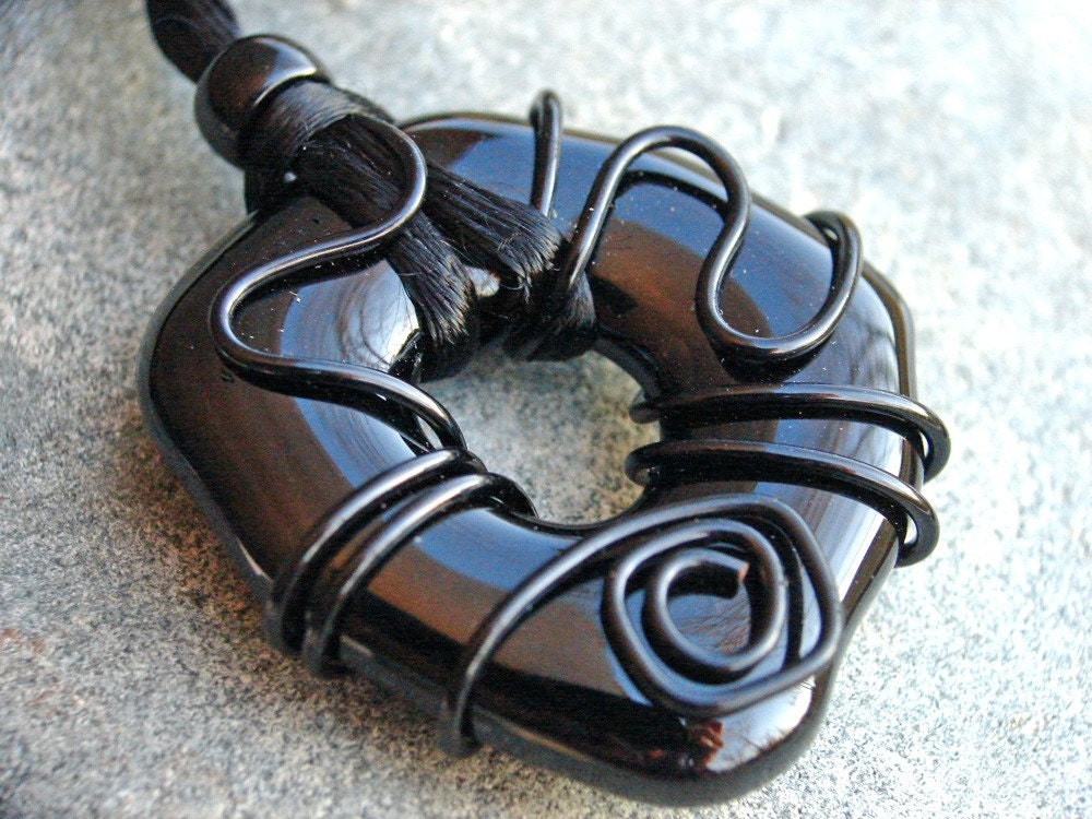 Simple black fused glass wire wrapped donut pendant on cord