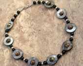 Serial Saturns Necklace